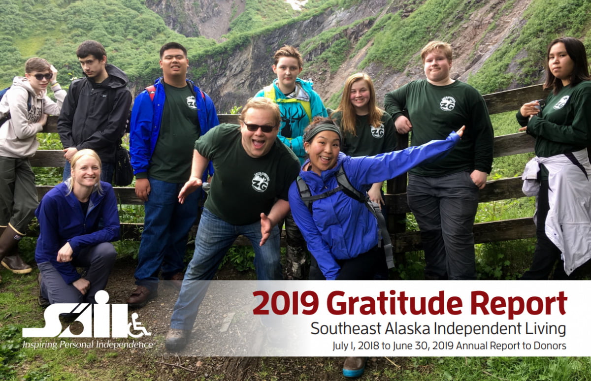front page of the 2019 annual report reads 2019 Gratitude Report. A group of 10 young people, many of them wearing matching green t-shirts, stand by a fence in front of a steep green slope.